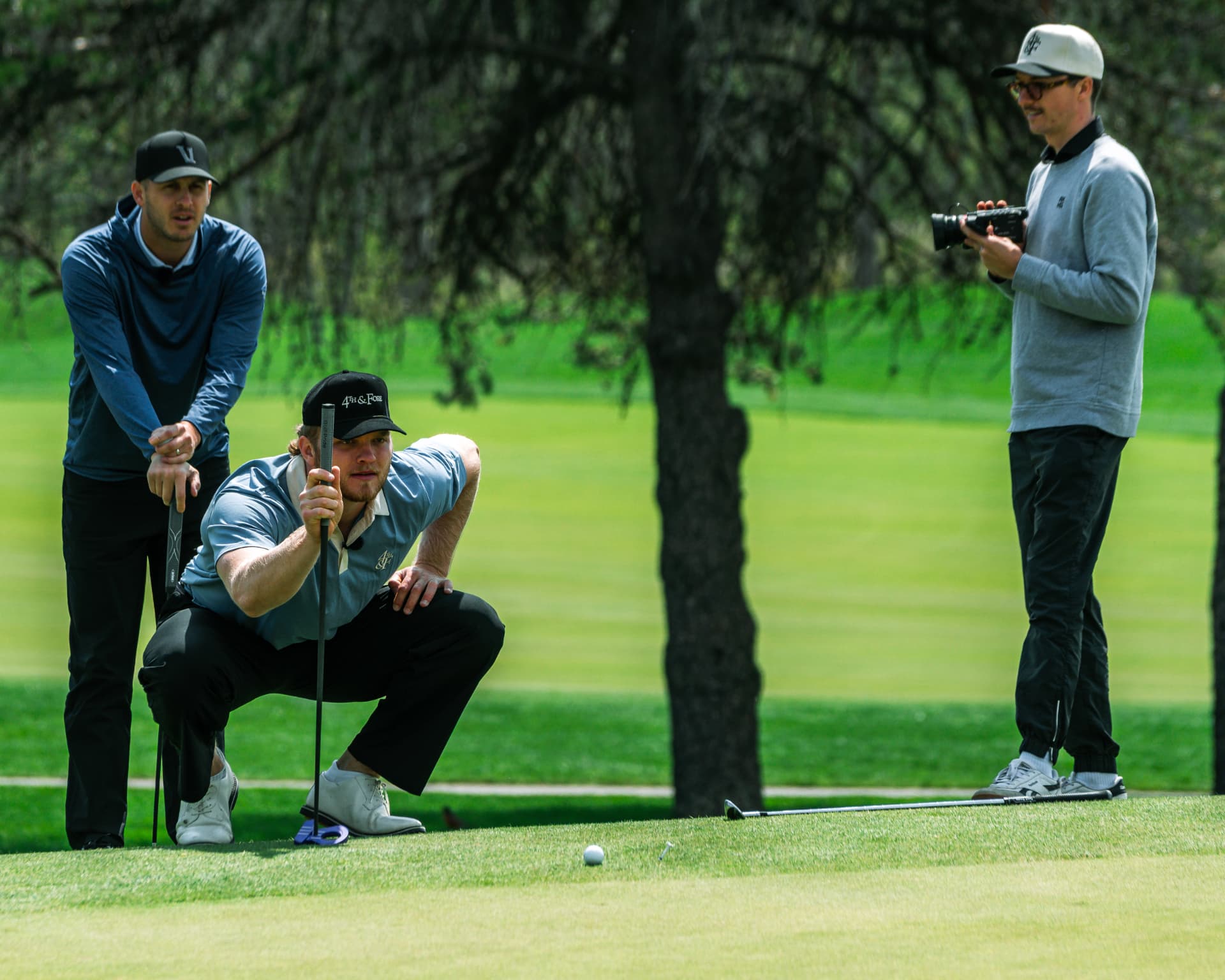 Players lining up a putt on the green during an episode